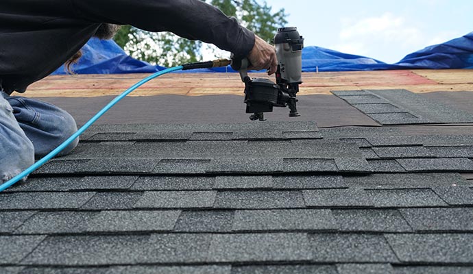 Worker installing roof